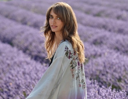 Woman walking in lavender field.