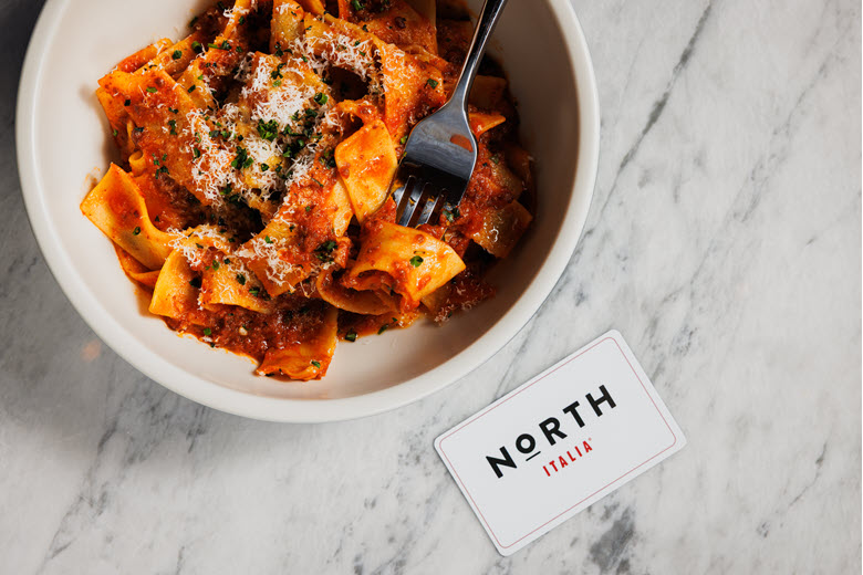 Bowl of Brea pasta with a North gift card on the table