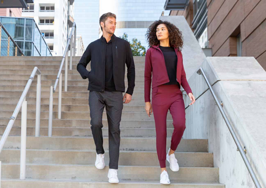 a man and woman walking down stairs in Athleisure clothes