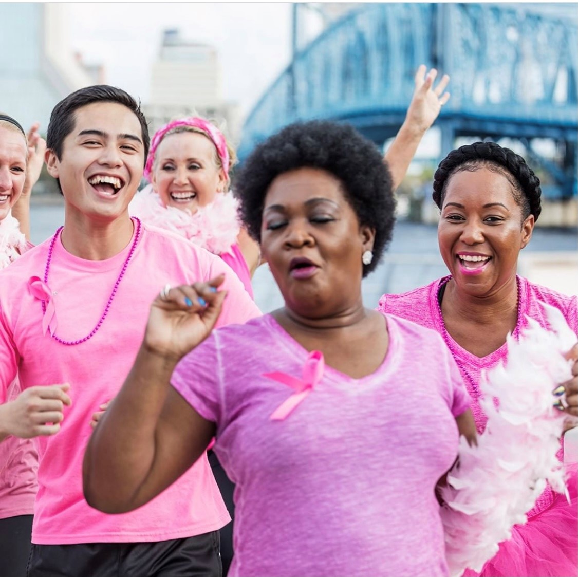mix of women and men walking in celebration of breast cancer awareness
