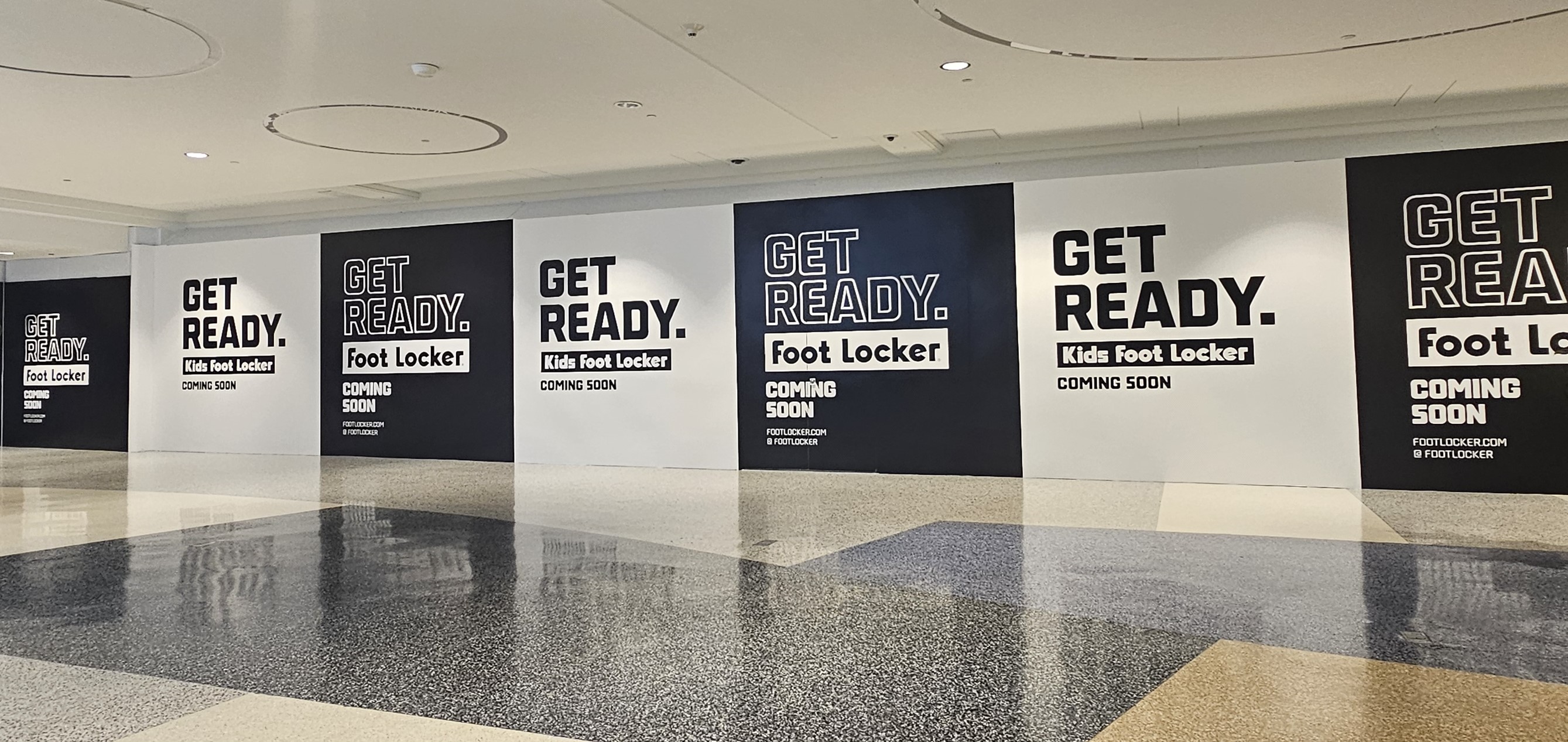 Black and white branded, Foot Locker barricade at Kings Plaza.