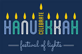 The words Celebrate Hanukkah with candle flames lit above the letters for Hanukkah on dark blue background