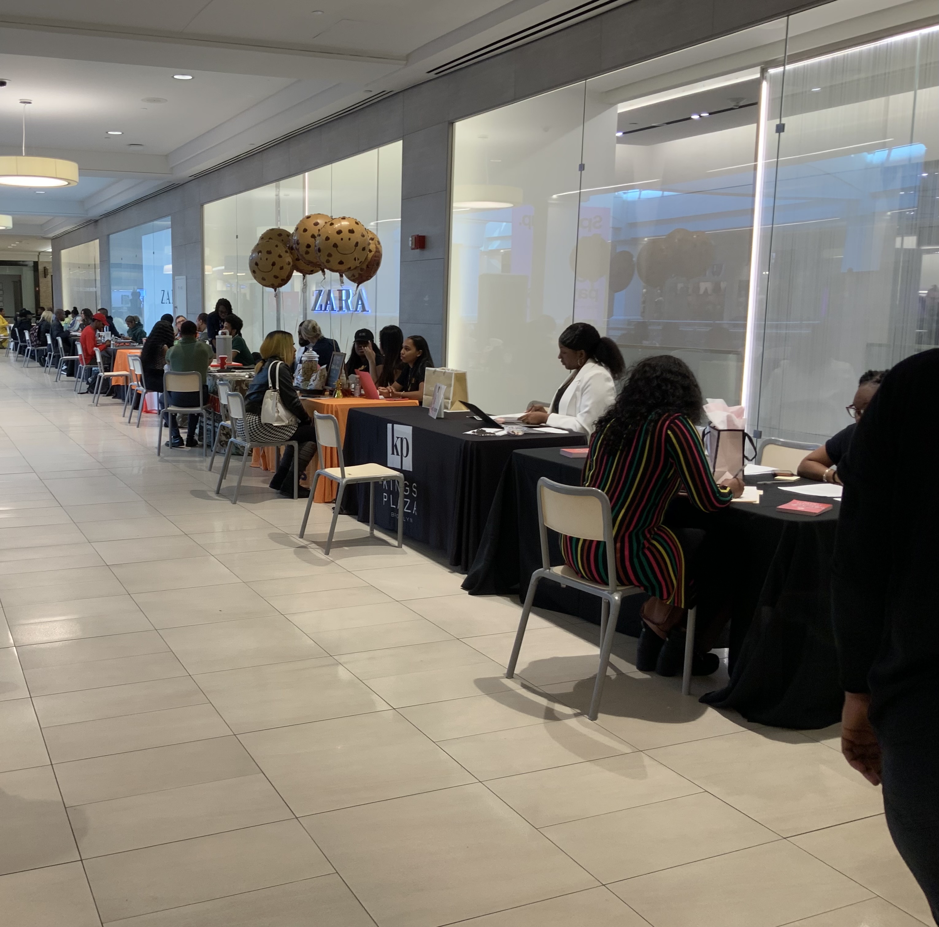 Retailers lined up along Zara store front to host job interviews.