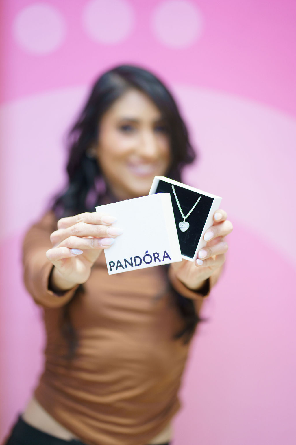 Woman holding a pandora box with heart necklace