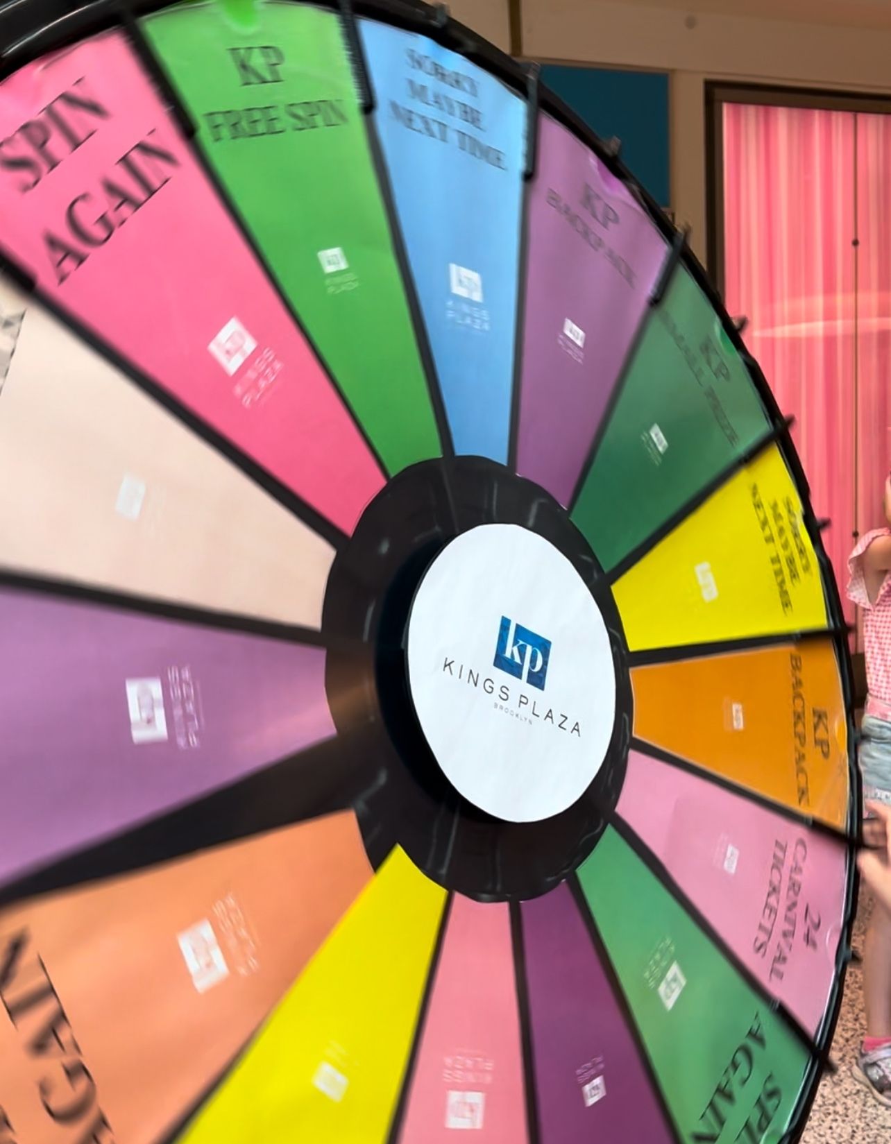 Kings Plaza rainbow colored prize wheel