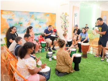 kids and adults participating in a drum circle