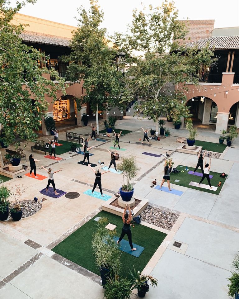 A group of women working out in an outdoor courtyard