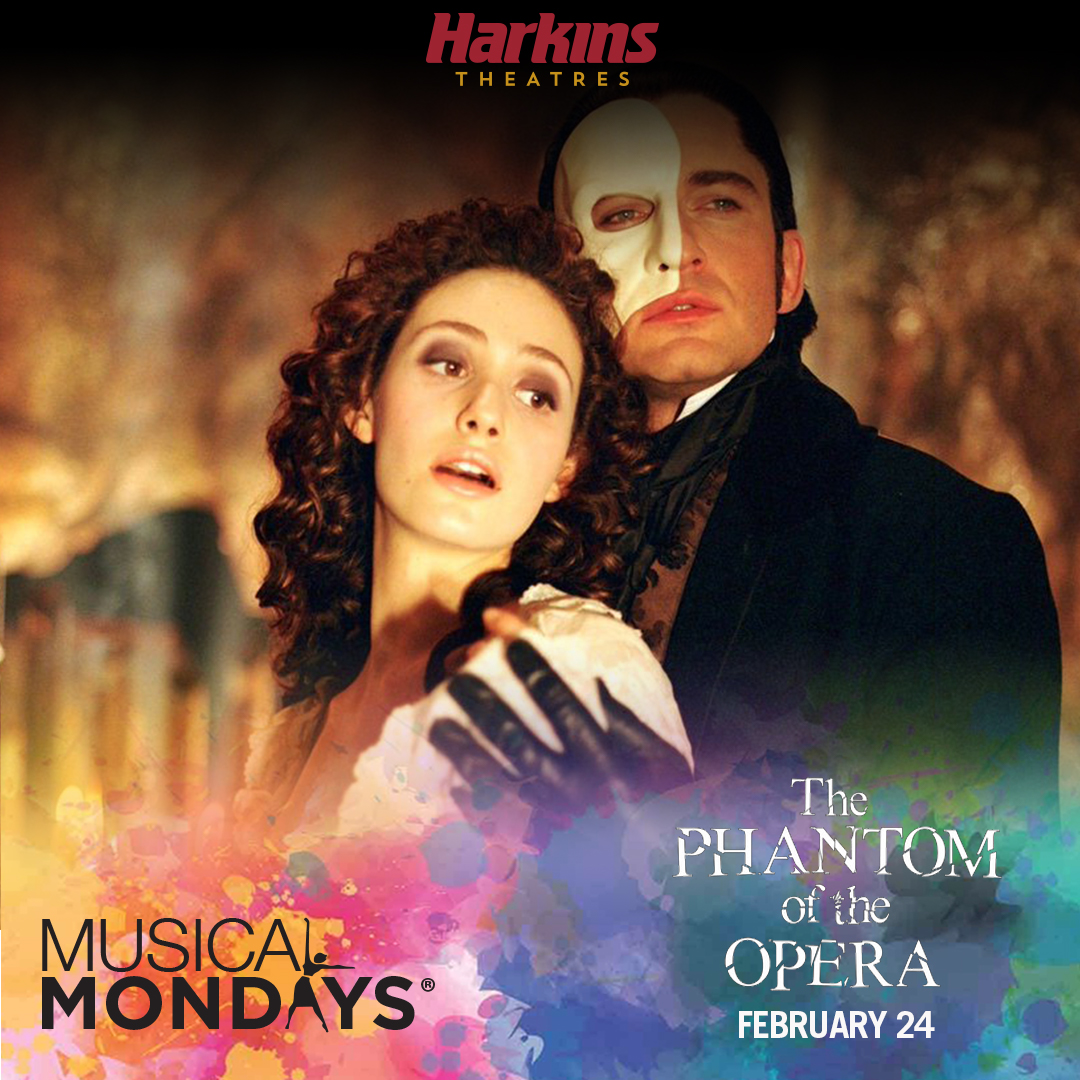 Main characters from the Phantom of the Opera pictured together. Dark haired women in a white dress and man in black suit with a mask.