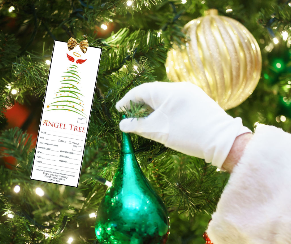 Santa Placing an Ornament on a Christmas Tree Near a Salvation Army Angel Tree Tag