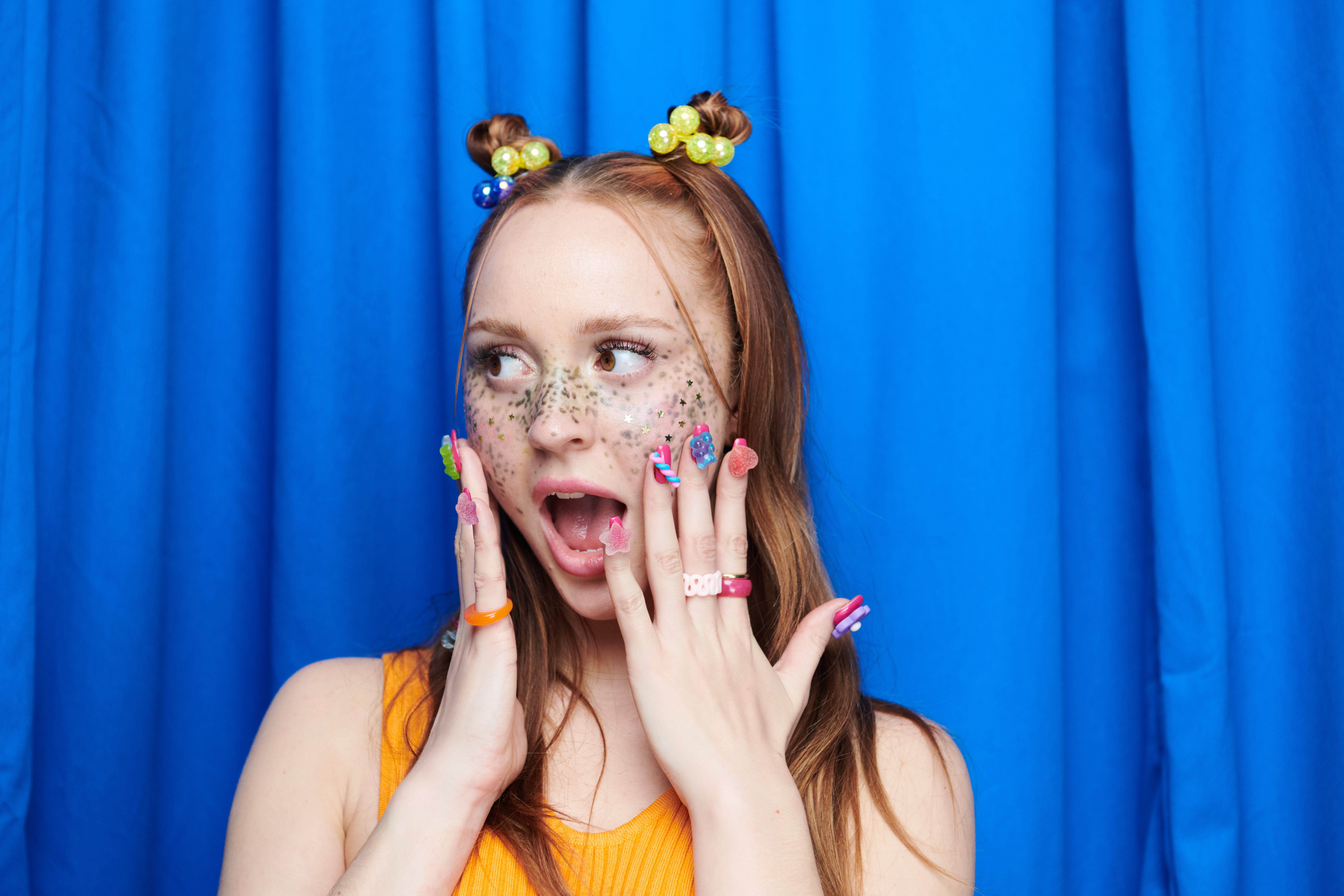 girl with funky nails looking surprised