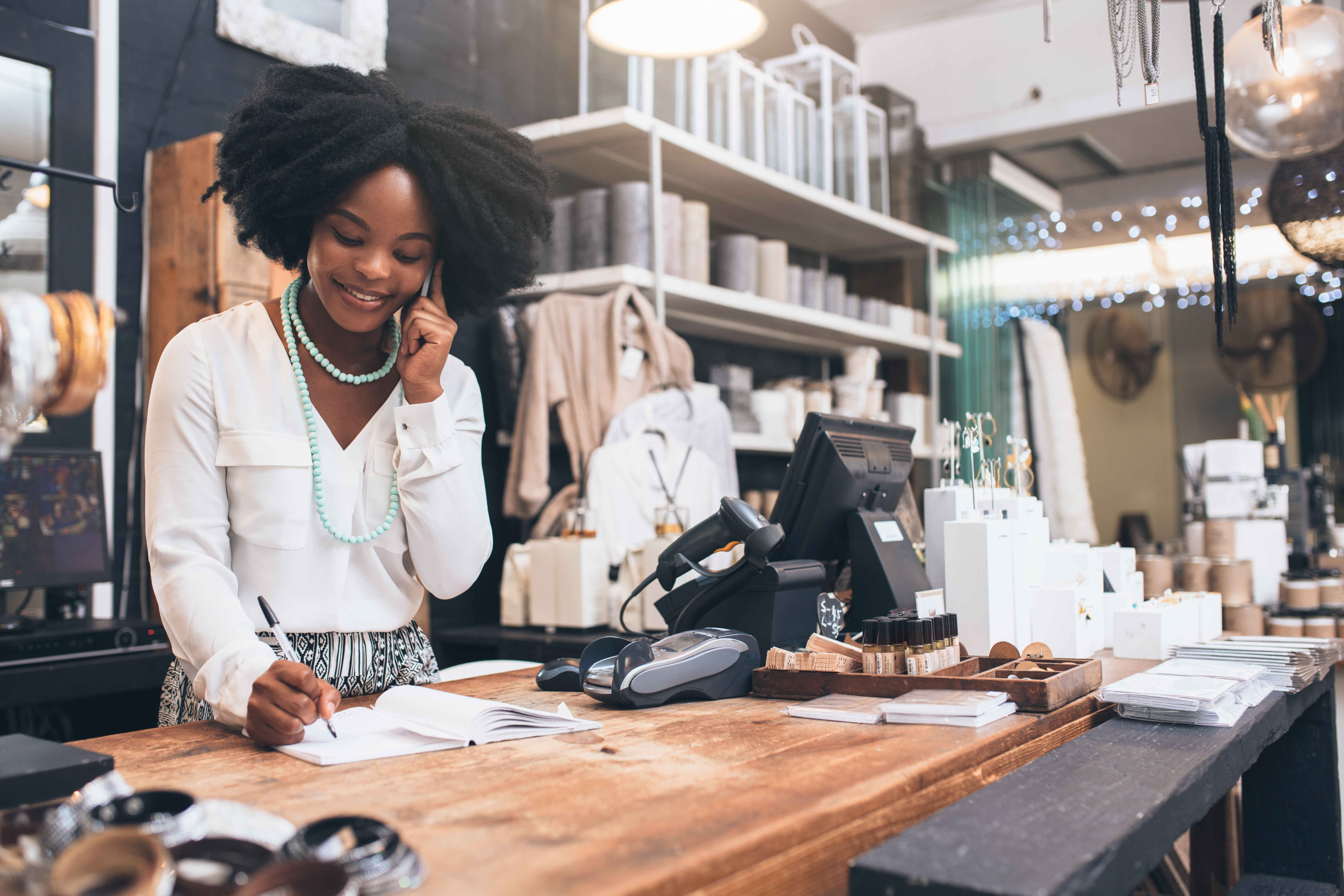Sales Associate at the counter on the phone