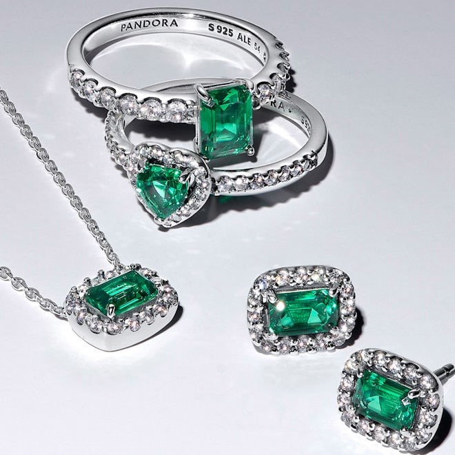 A necklace, earrings, and rings with matching green stones