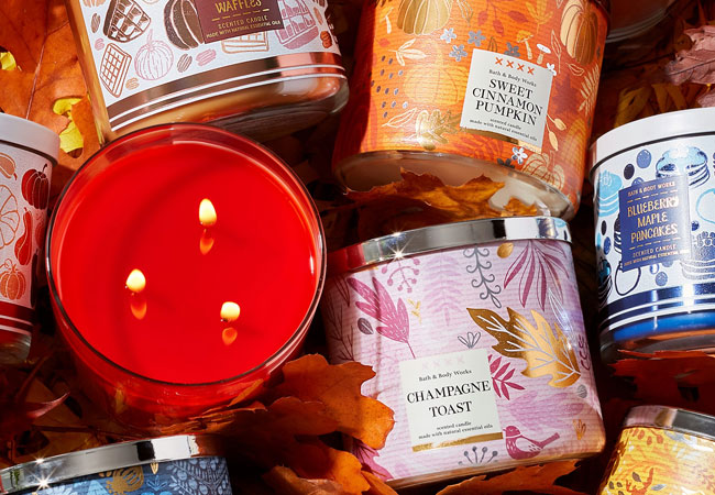 pile of Bath & Body works 3-wick candles 