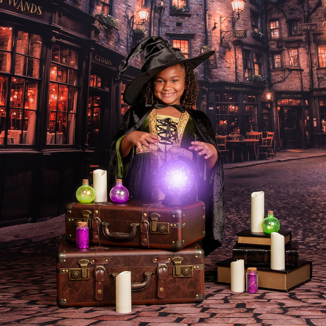 Young girl dressed as a wizard making magic. 