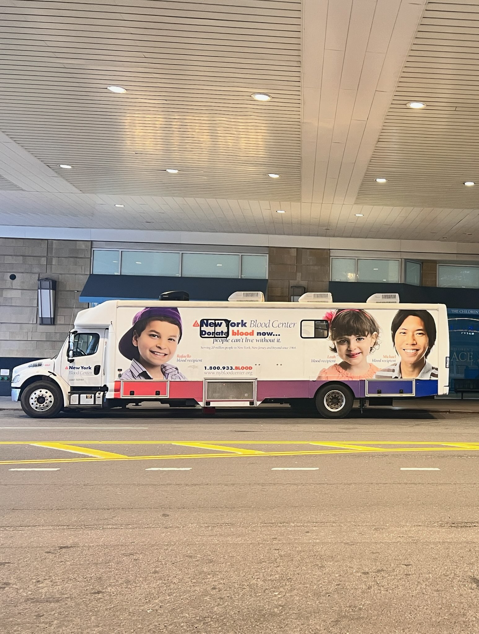 New York Blood Center mobile bus parked outside of Queens Center mall. 