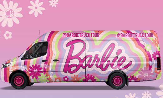 Colorful van with flower prints on a pink background.