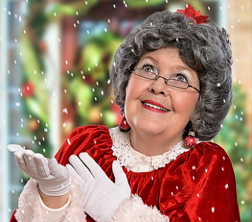 Mrs. Claus catching falling snowflakes in her white gloved hands. 
