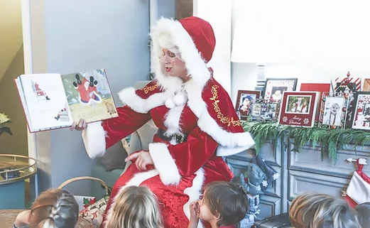 Mrs. Claus reading to children.