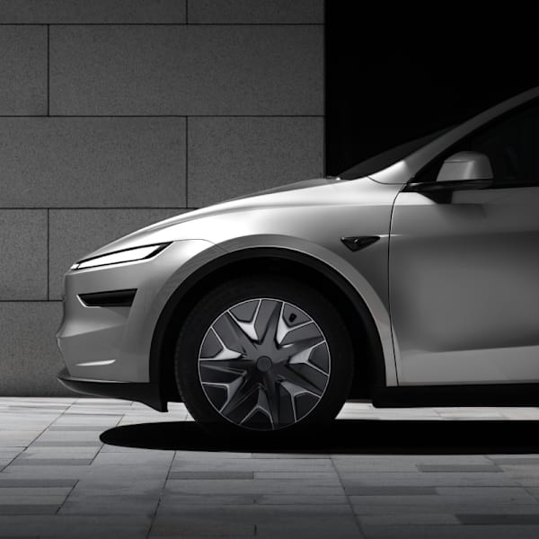 Front end of a silver Tesla model Y.