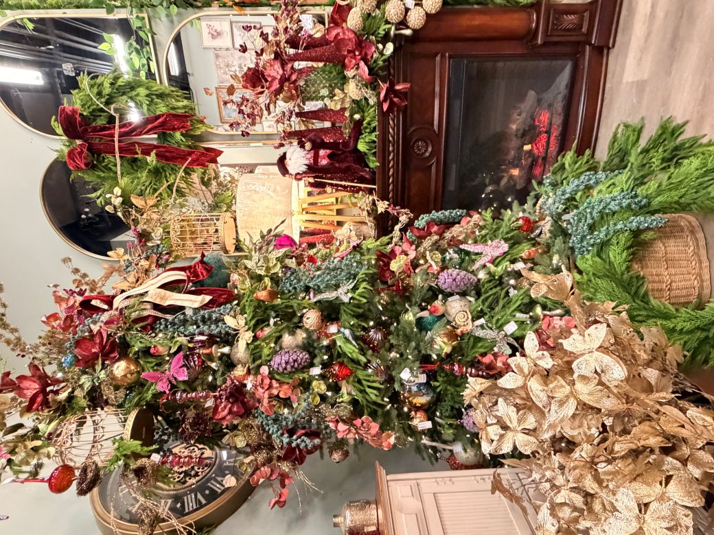 Christmas decor in a store with a lit fireplace.