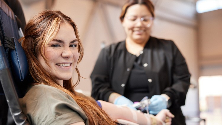 Woman smiling while donating blood.