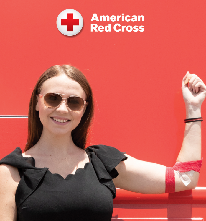 Woman holding her arm up after giving blood