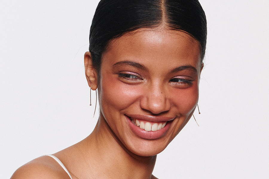 model smiling and looking off camera