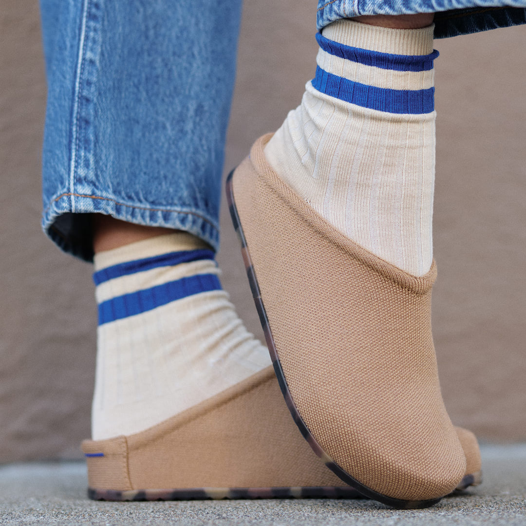 close up shot of person wearing clogs