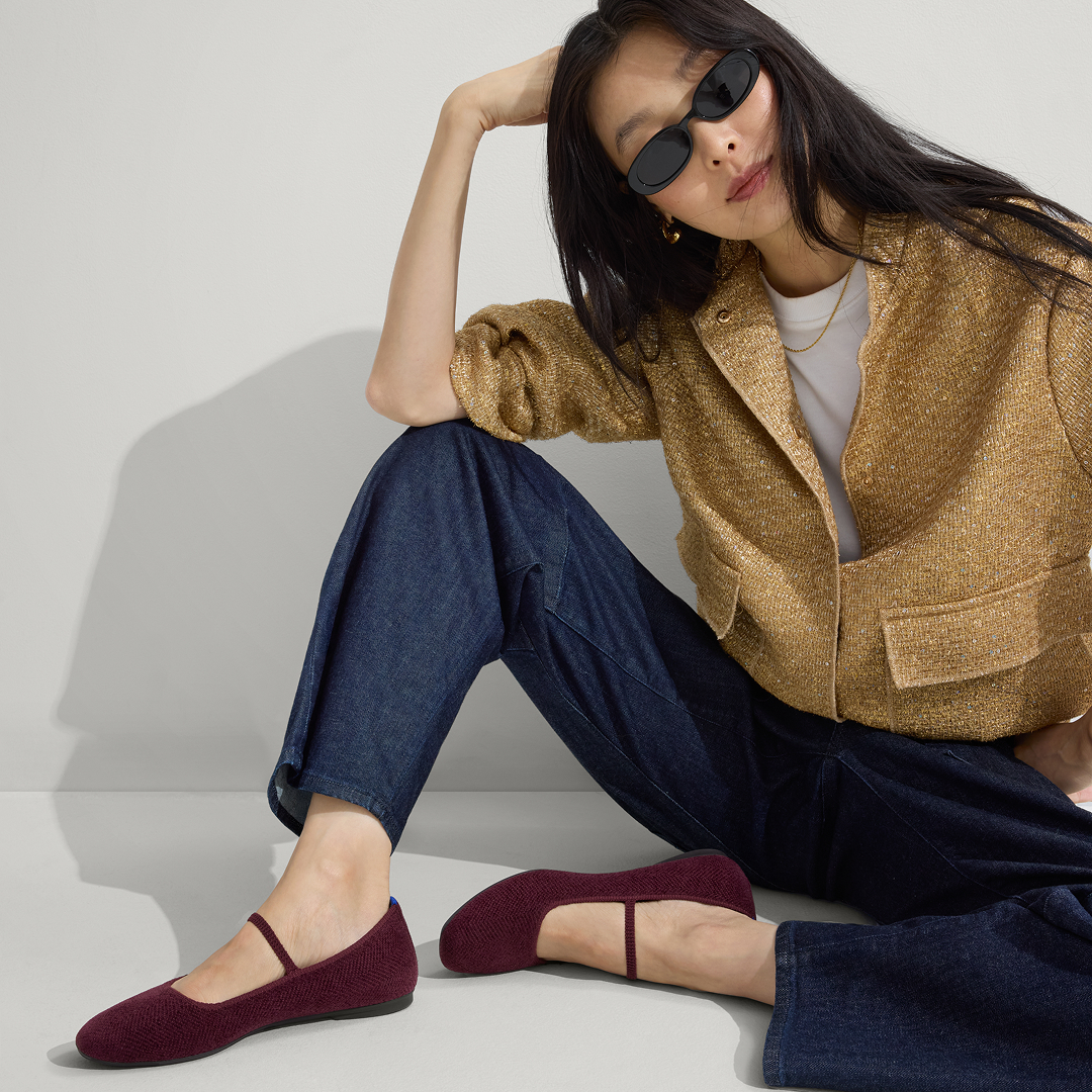 model posing in maroon flats