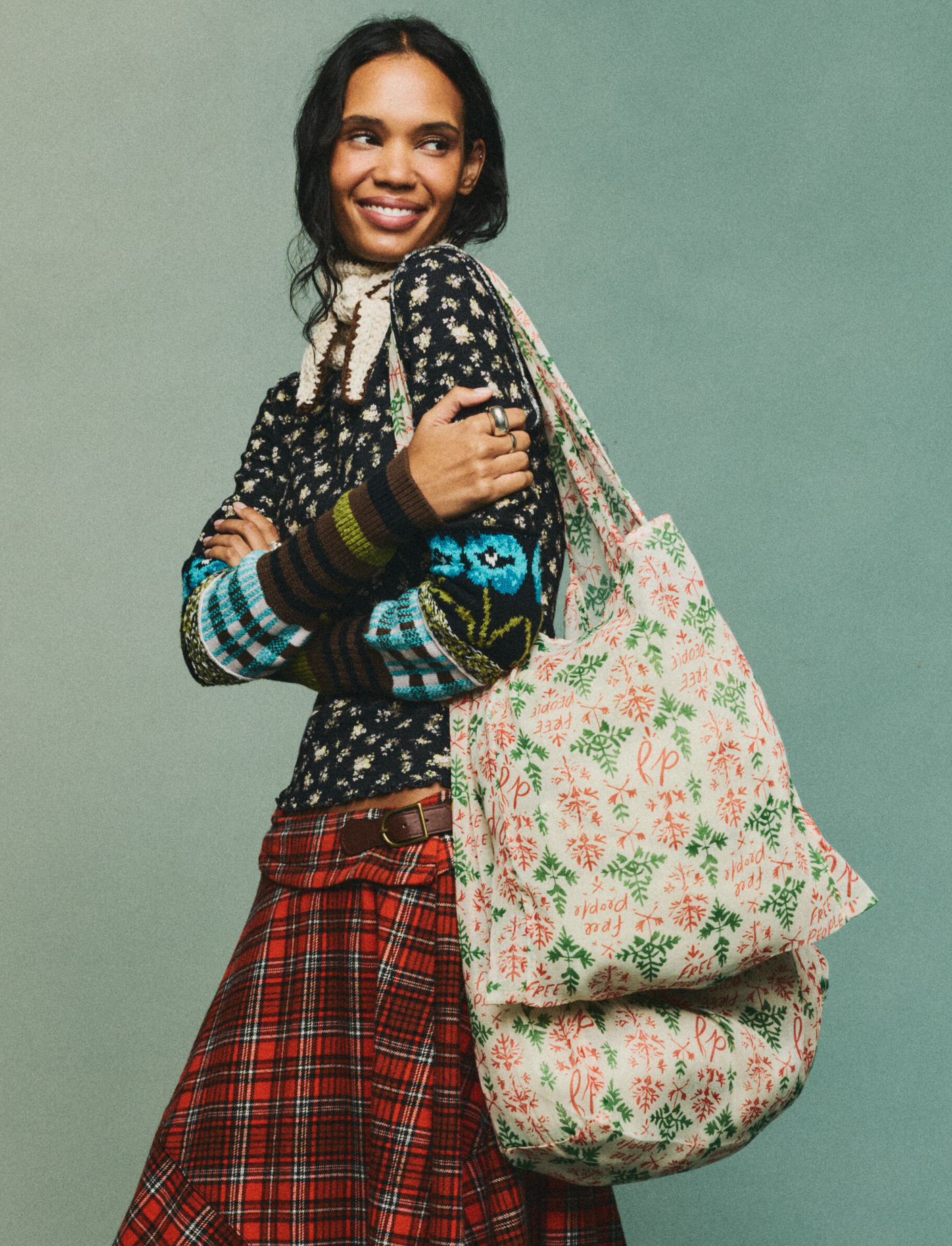 model posing and smiling wearing the christmas tote on her shoulder