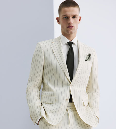 male model in a white pinstripe suit