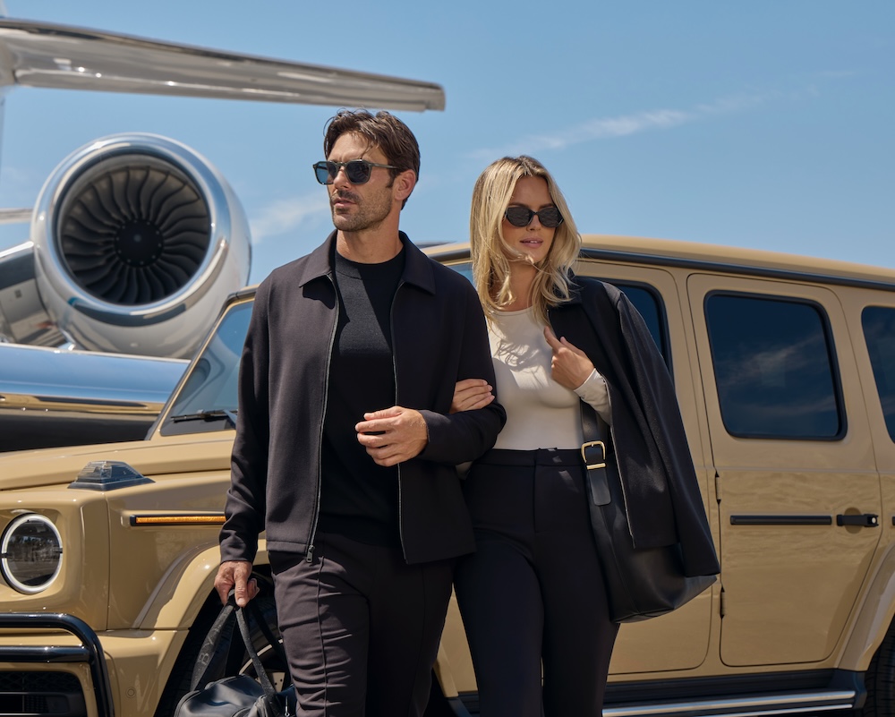 male and female model posing in front of car in sunglasses and bylt clothing 