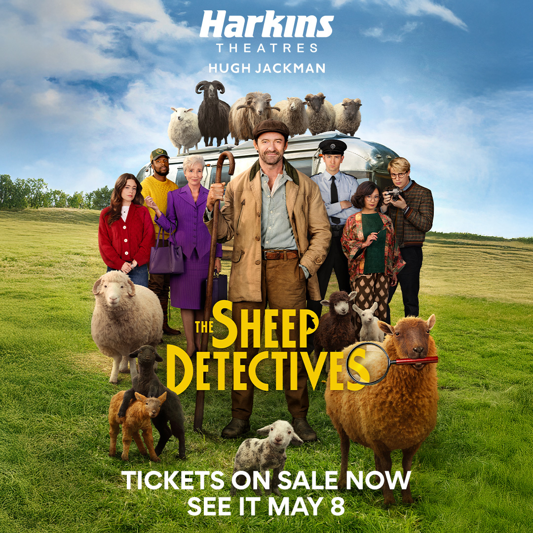 all of the cast of the movie along with the sheep standing in a field 