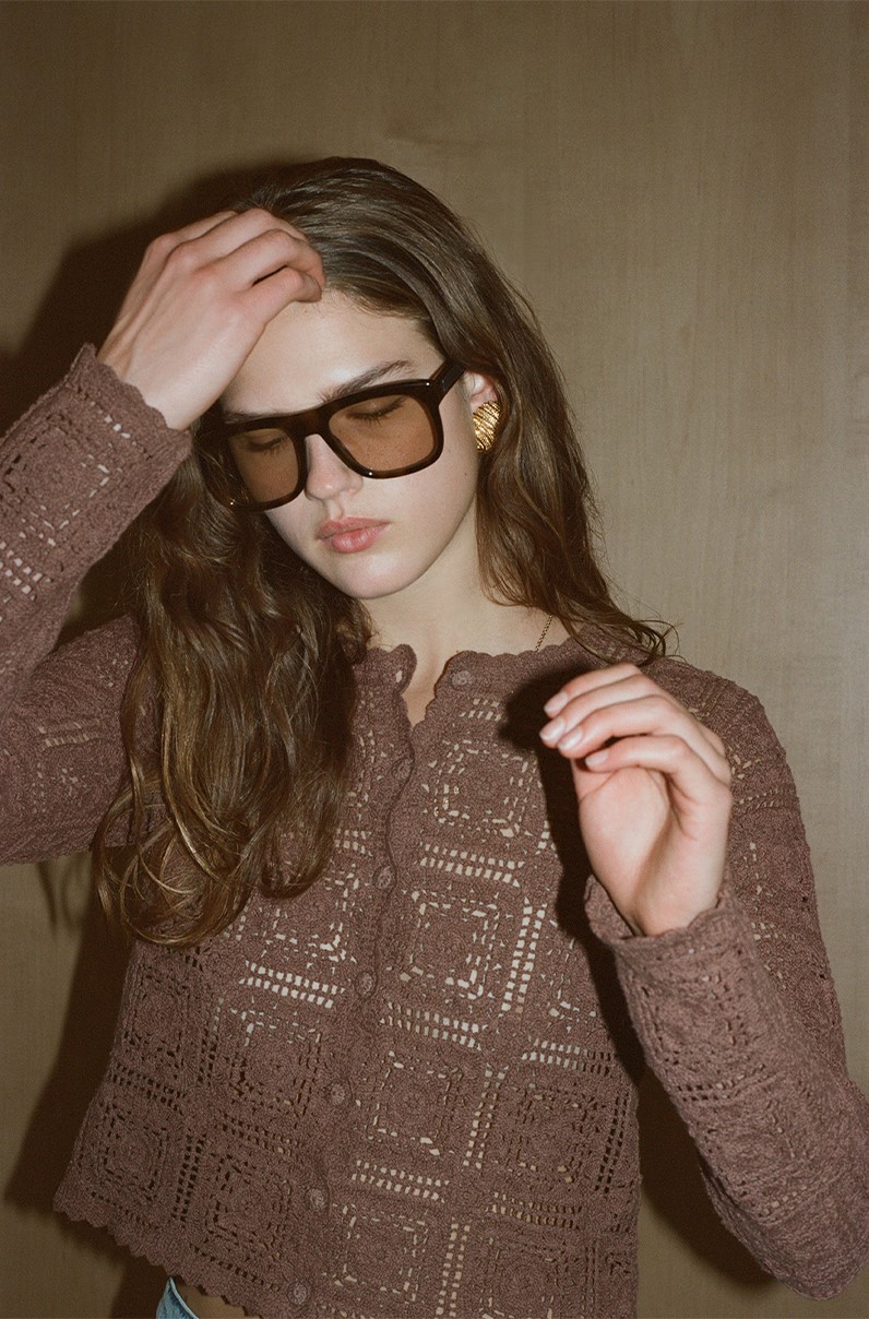 model looking down wearing sunglasses