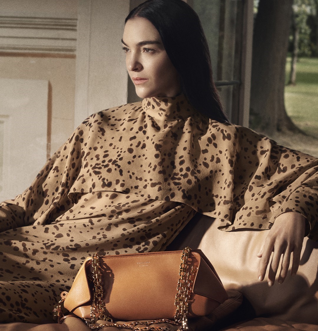 model posting with brown ferragamo bag