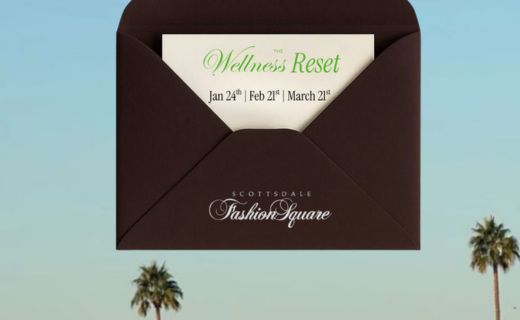the wellness reset invite against a blue sky with palm trees