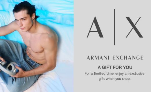 shirtless male model in jeans holding headphones with armani exchange logo. a gift for you for a limited enjoy an exclusive gift when you shop