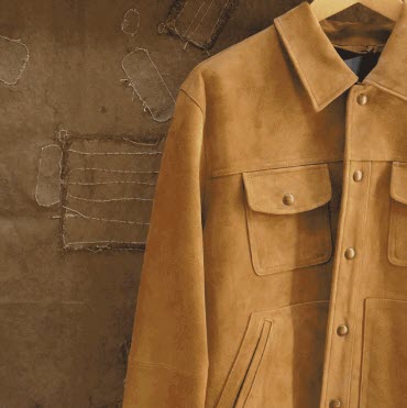 tan suede jacket against a safari backdrop wall
