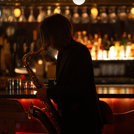 silhouette of man playing the saxophone