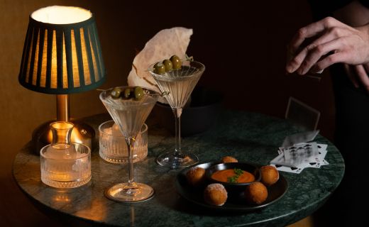 cards, martinis, and meatballs on a table 