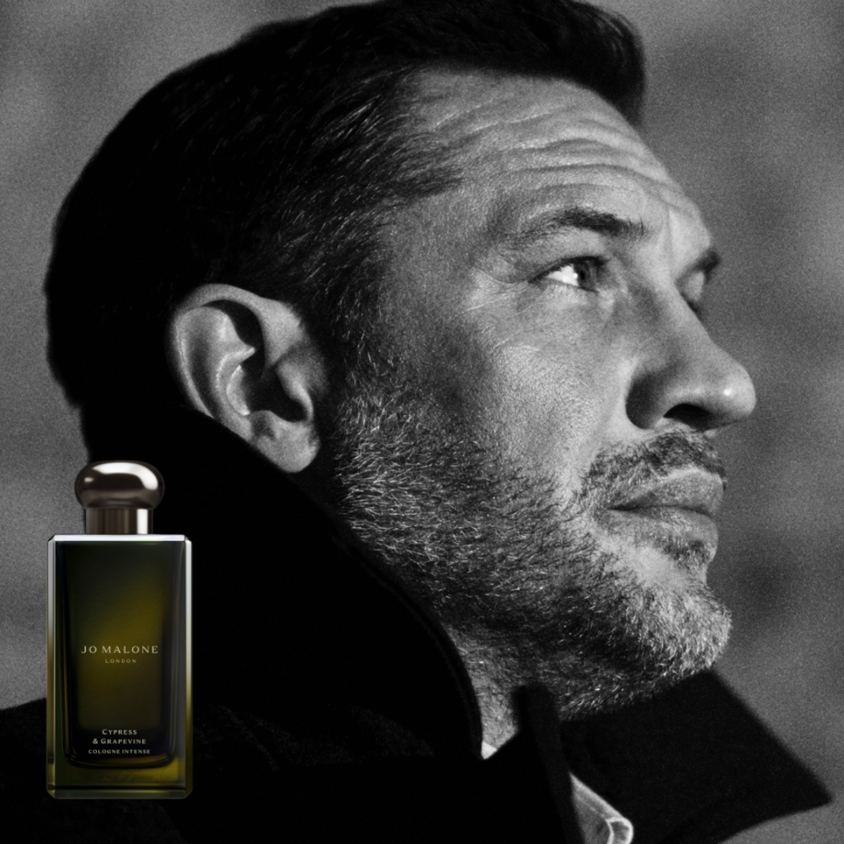 fragerance bottle with tom harding looking off to the side 
