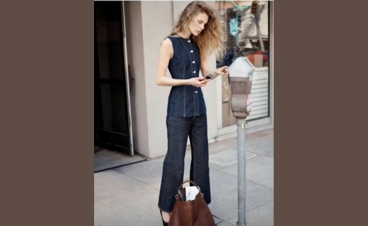 model wearing jean outfit looking down