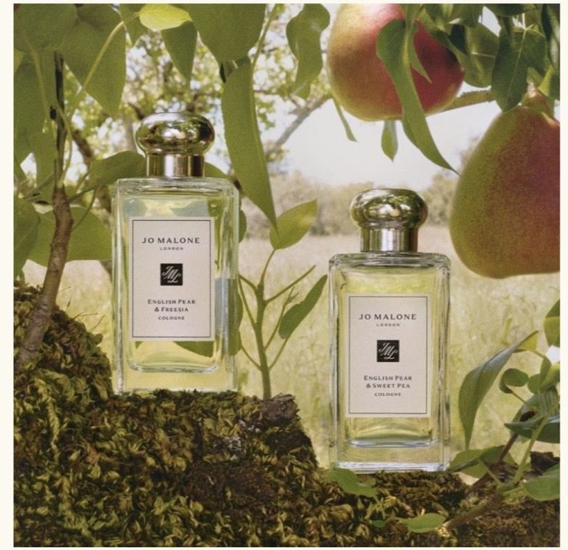 jo malone cologne bottles against greenery background 