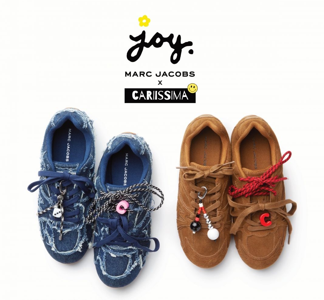 joy marc jacobs x carissima logo with 2 pairs of sneakers with charms on them 