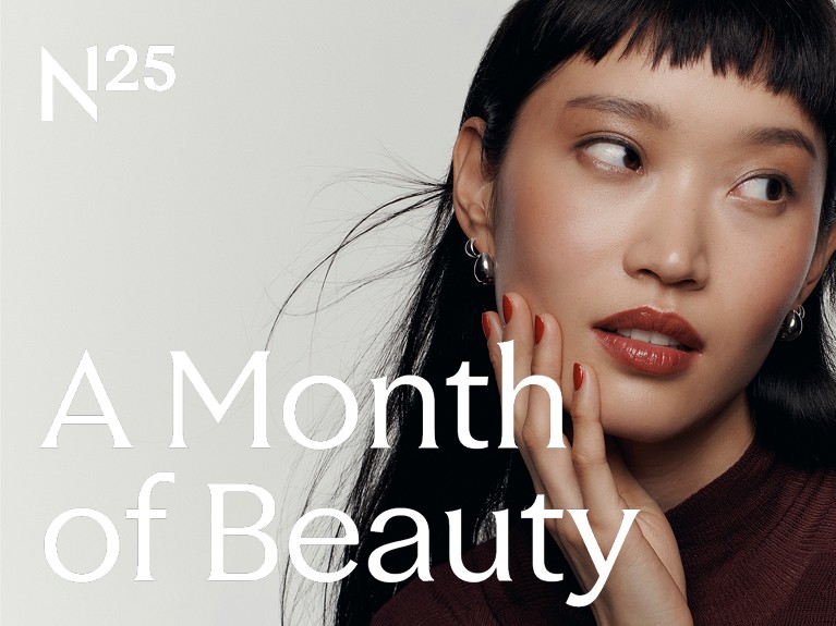 n125 logo with a month of beauty with a model touching her face and looking away