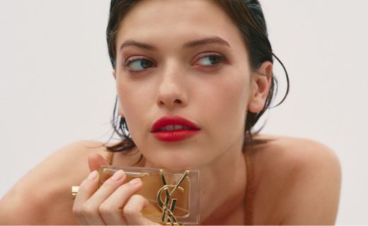 model holding a bottle of perfume 