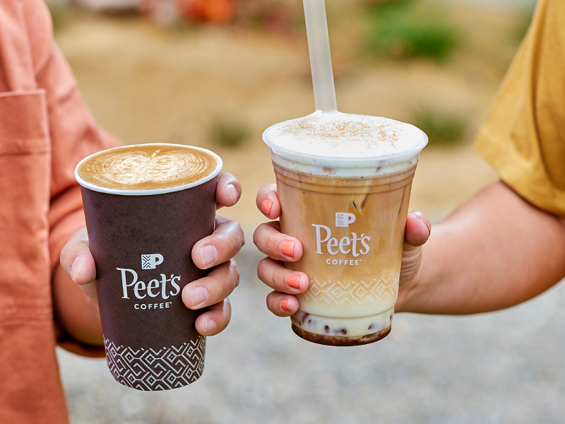 hands holding hot and cold Peet's coffee. 