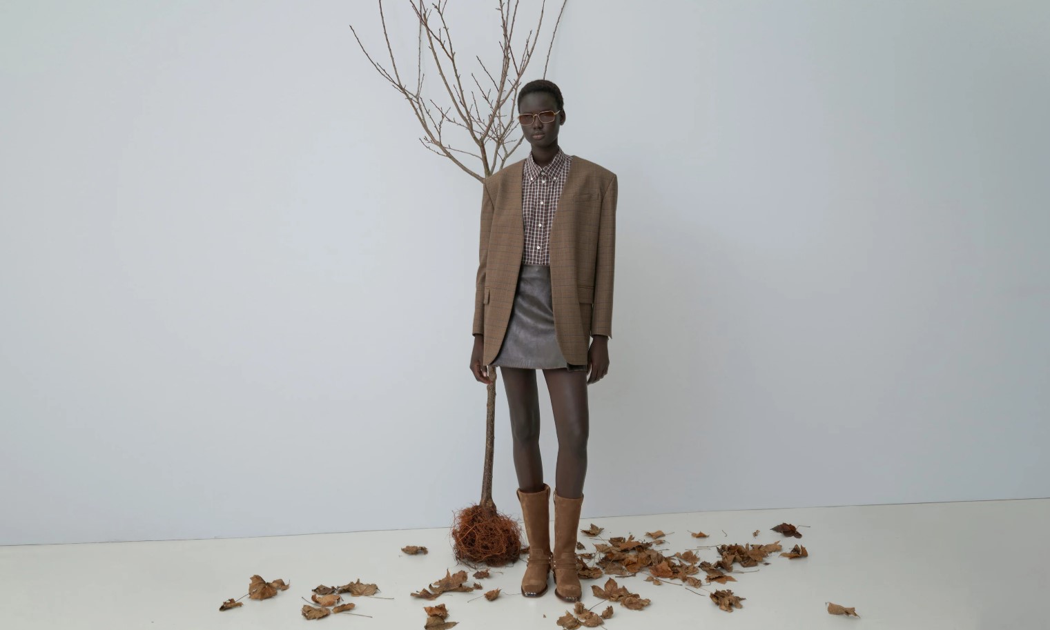 female model in winter jacket, button down shirt, skirt