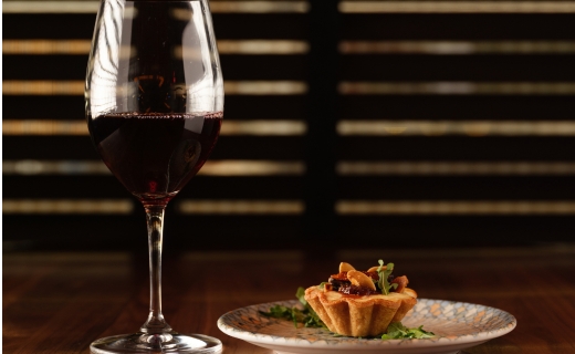 glass of wine and tart on a table 