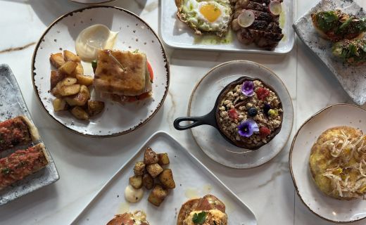brunch spread on a table with oatmeal, eggs, potatoes, and more